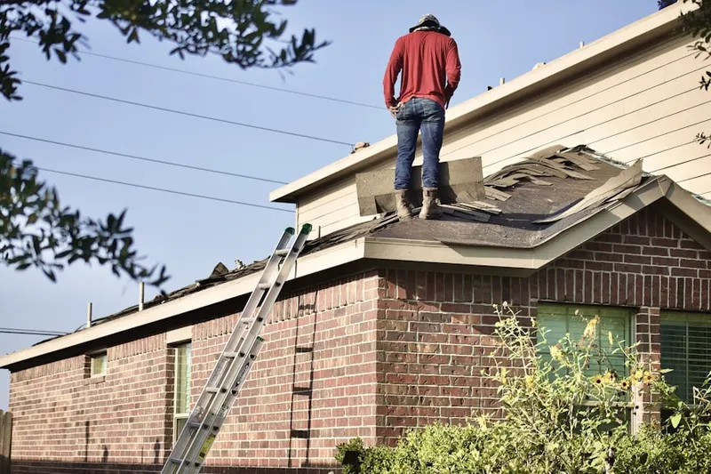 Professional roofer working on a residential roof in Medford